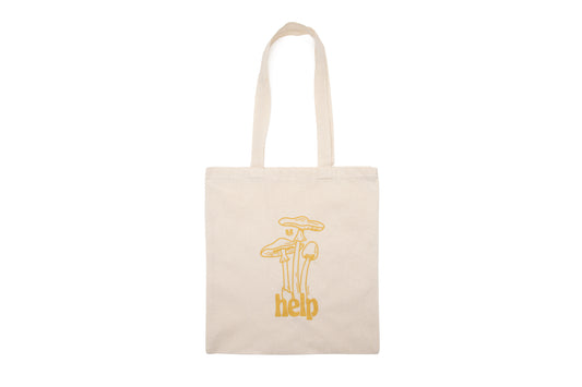 Canvas tote bag with a graphic of mushrooms sprouting out of the word "Help". Gold in color.