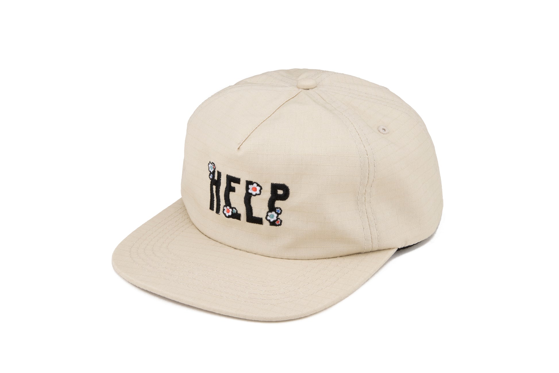 Stone colored 5 panel hat with an embroidered design that says "Help" on the front. The design includes flower embroidery on top of each letter. The material is ripstop cotton.