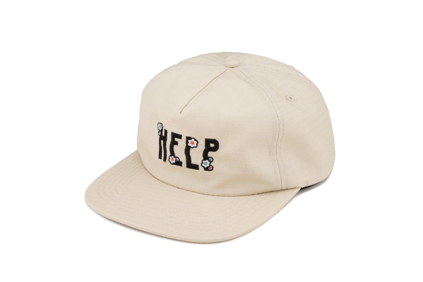 Stone colored 5 panel hat with an embroidered design that says "Help" on the front. The design includes flower embroidery on top of each letter. The material is ripstop cotton. 