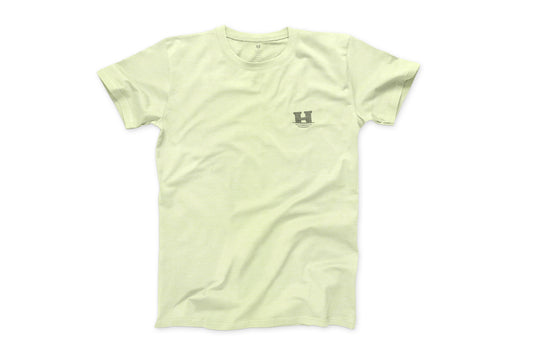 This is a photo of the front of the "Daily Tee". The shirt is a light pale green and has a small "sinking H" logo on the left chest. 